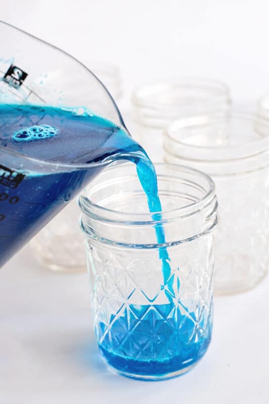 pour blue jello evenly between jars.