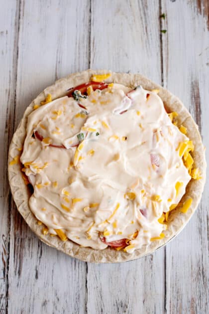 Tomato pie with mayonnaise spread on top.