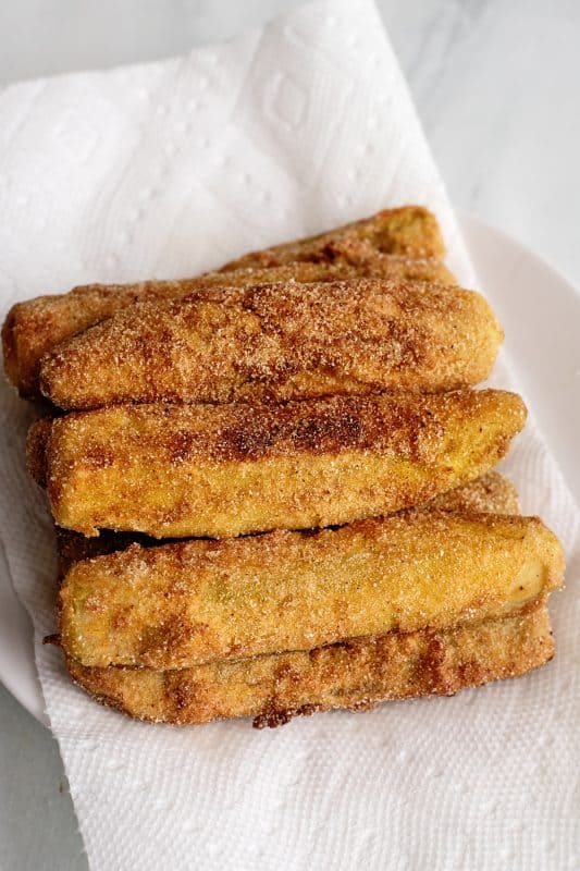 turn them to cook all sides and place each fried pickle on paper towel