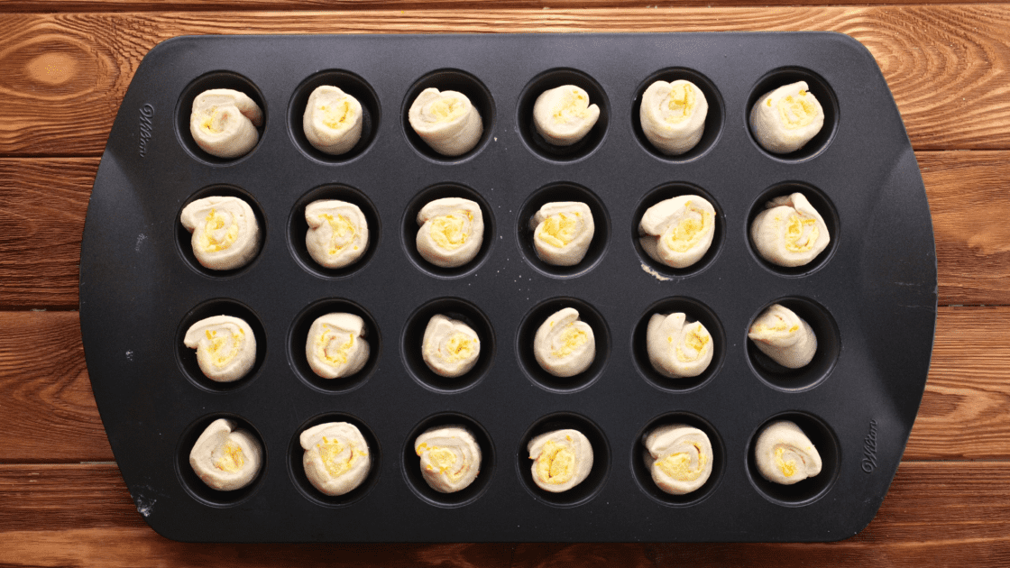 Place one roll into each cup of a mini muffin tin.