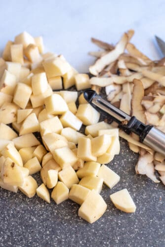 Peel and chop potatoes into cubes.