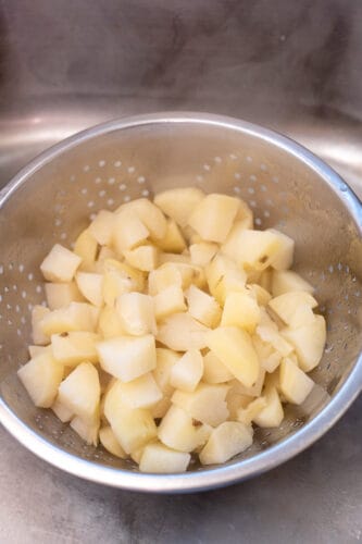 Drain potatoes in colander.