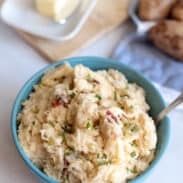 Bowl of cheesy garlic mashed potatoes with mozzarella.
