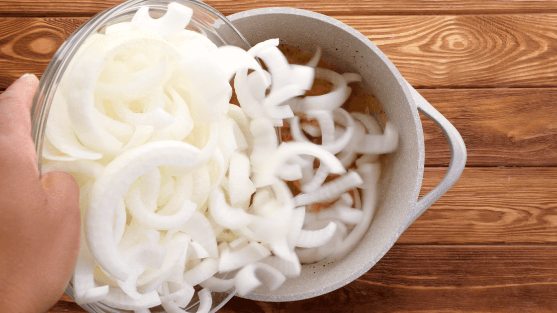 Dump onions into saucepot and stir to coat.