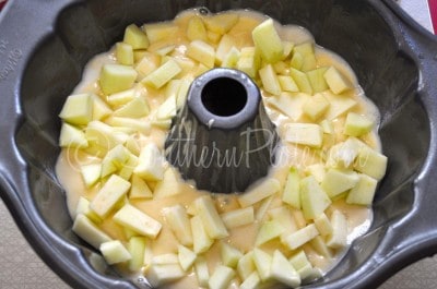 Place half cake batter in bundt pan and top with half chopped apples.