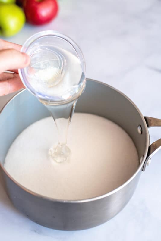 Pouring light corn syrup into the sugar