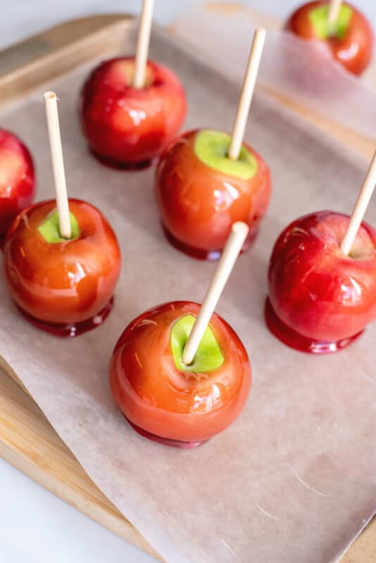 Candy apples cooling on parchment paper