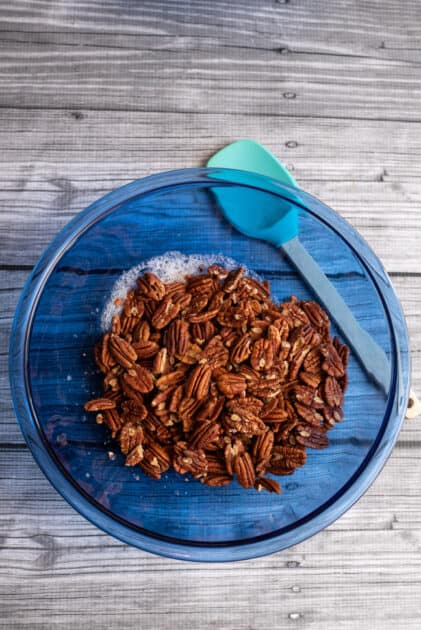 Add pecans to egg white bowl.