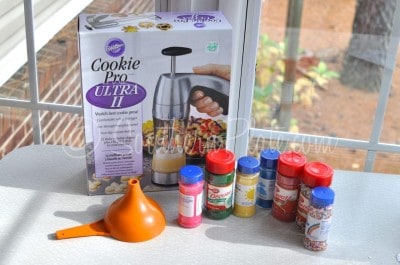 Cookie press with colored sprinkles.