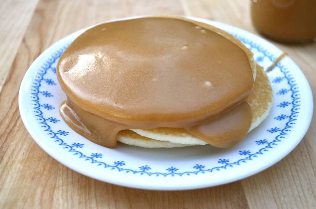 Peanut butter syrup on a stack of pancakes.