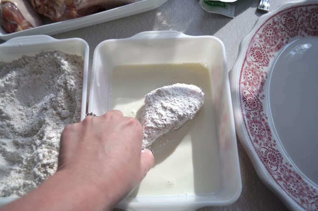 Fuss Free Fried Chicken - This is a way to actually fry chicken, in oil, in your oven Placing flour coated chicken drumstick in a shallow dish of milk.