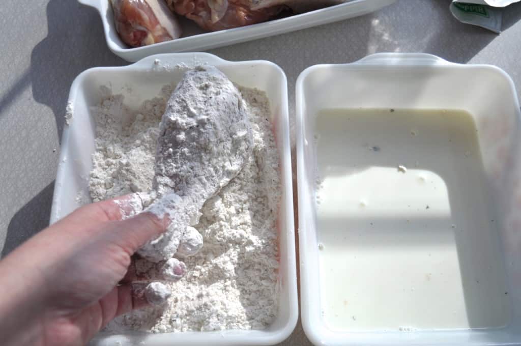 Fuss Free Fried Chicken - This is a way to actually fry chicken, in oil, in your oven Placing flour coated chicken drumstick in a shallow dish of flour.