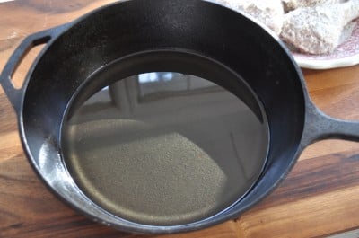 Heat oil in cast iron skillet in oven.