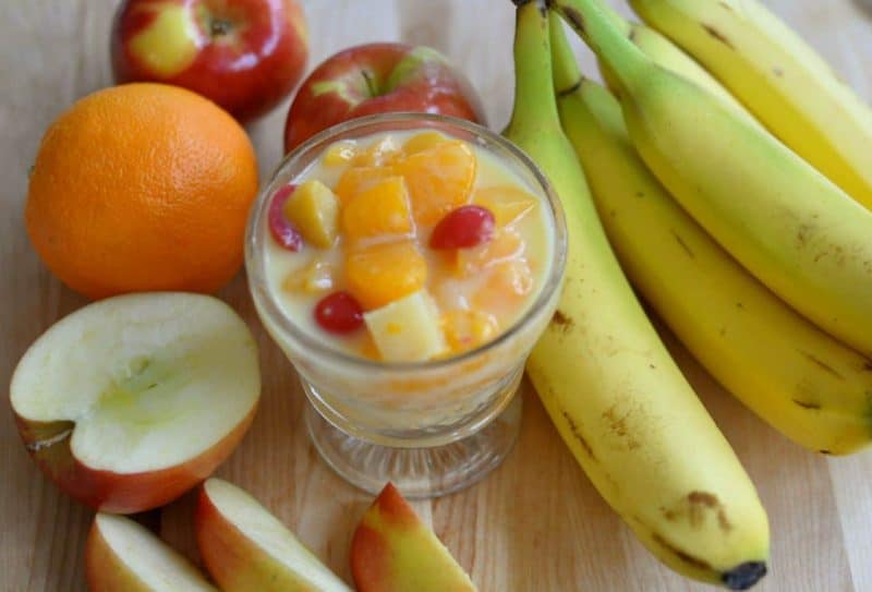 Cup of fruit salad with vanilla pudding.