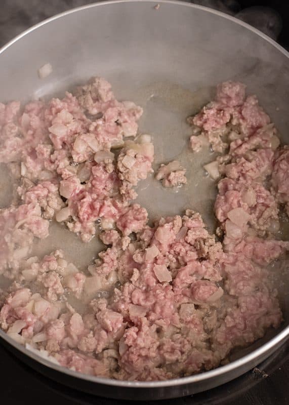 Brown ground beef and onions in skillet.
