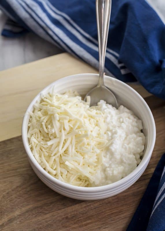 Mix both types of cheese together in small bowl.