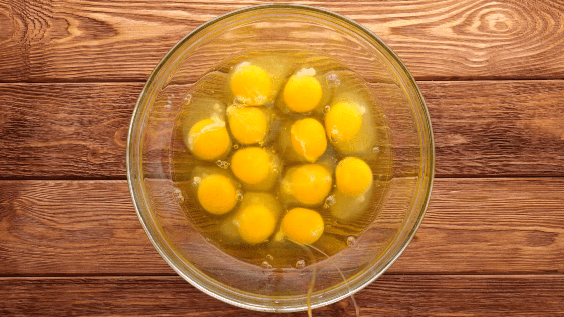 Crack a dozen eggs into a medium bowl.