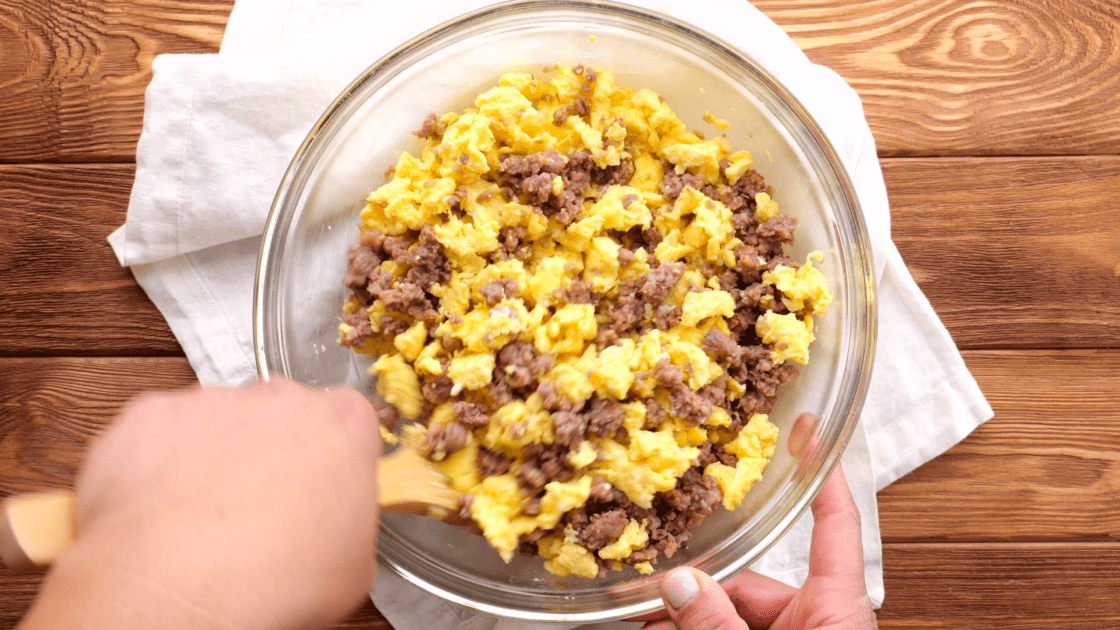 Combine eggs and sausage in mixing bowl.