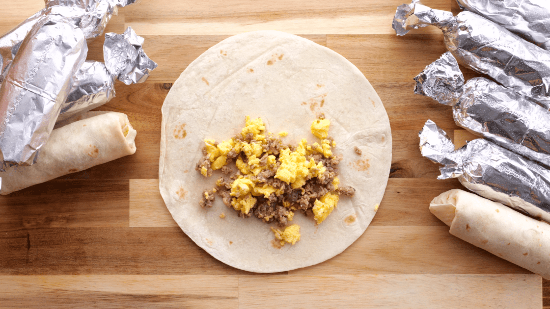 Add sausage and egg mixture to the tortilla.