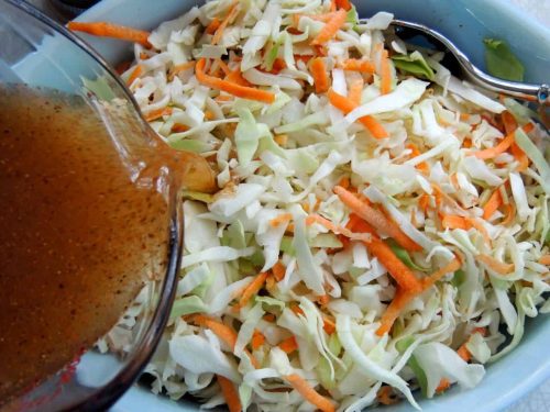 Pour vinegar mixture over coleslaw in large bowl.