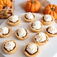 Serving plate filled with mini pumpkin pies.