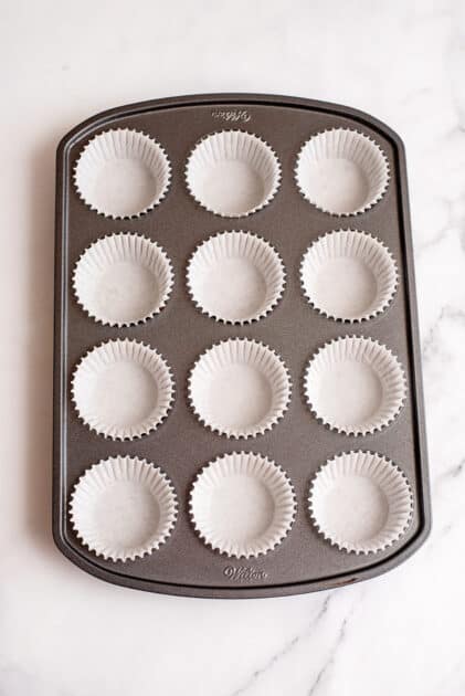 Put cupcake papers in a muffin tin.