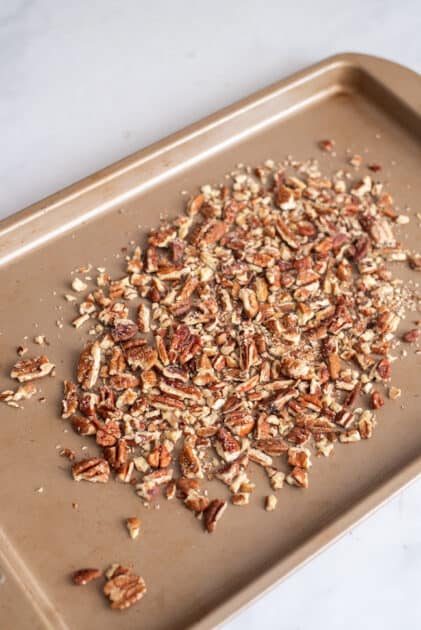 Toast pecans on baking sheet.