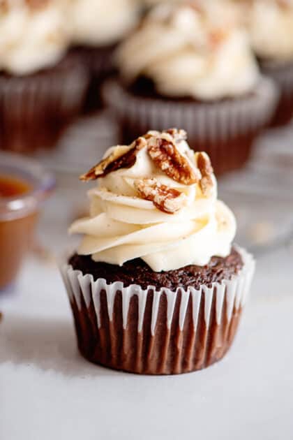 Add toasted pecans to frosting on the Rolo cupcakes.