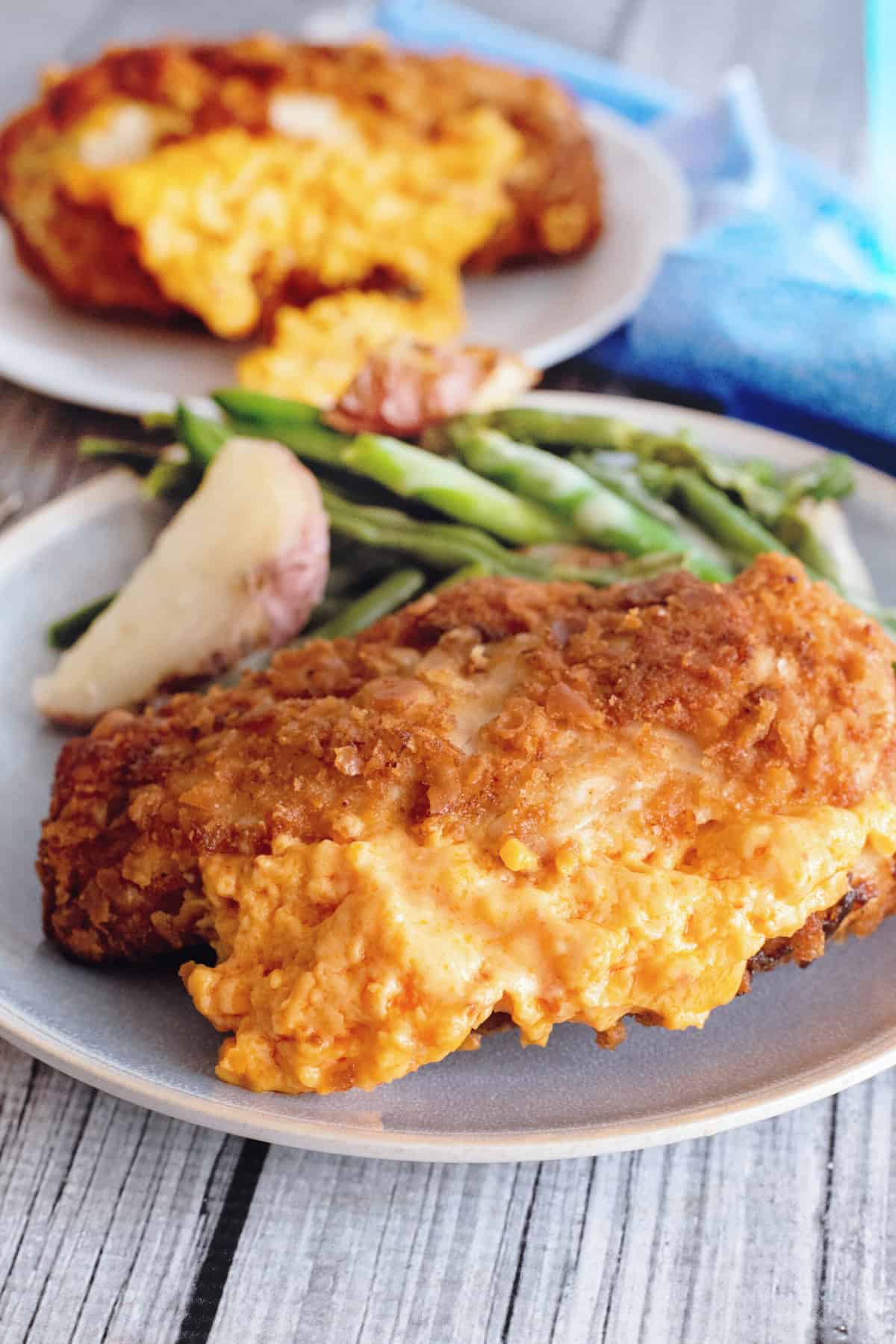 Plate with fried chicken cordon bleu and sides.