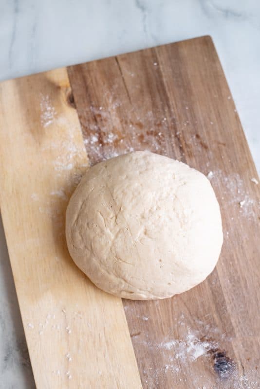 slightly larger ball of dough after rising, uncover the dough