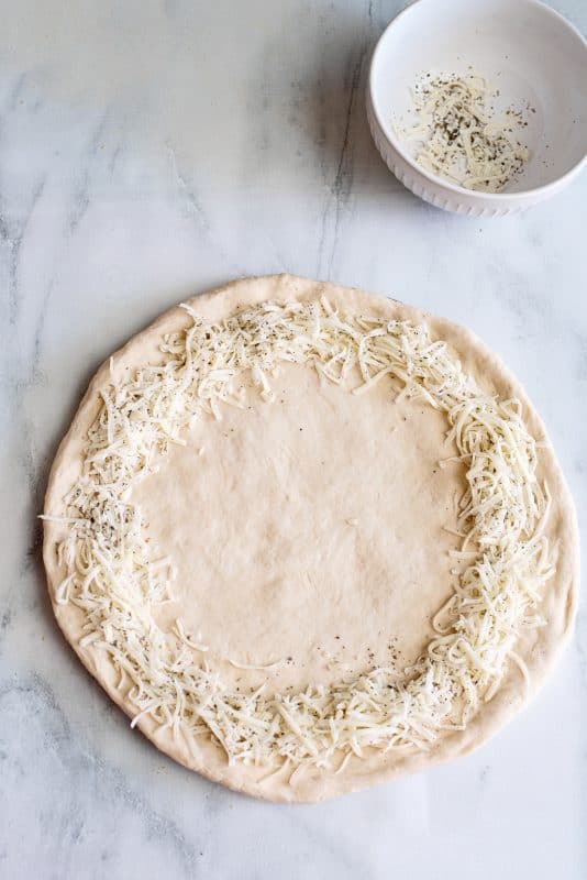 sprinkle the mozzarella and herbs along the edges