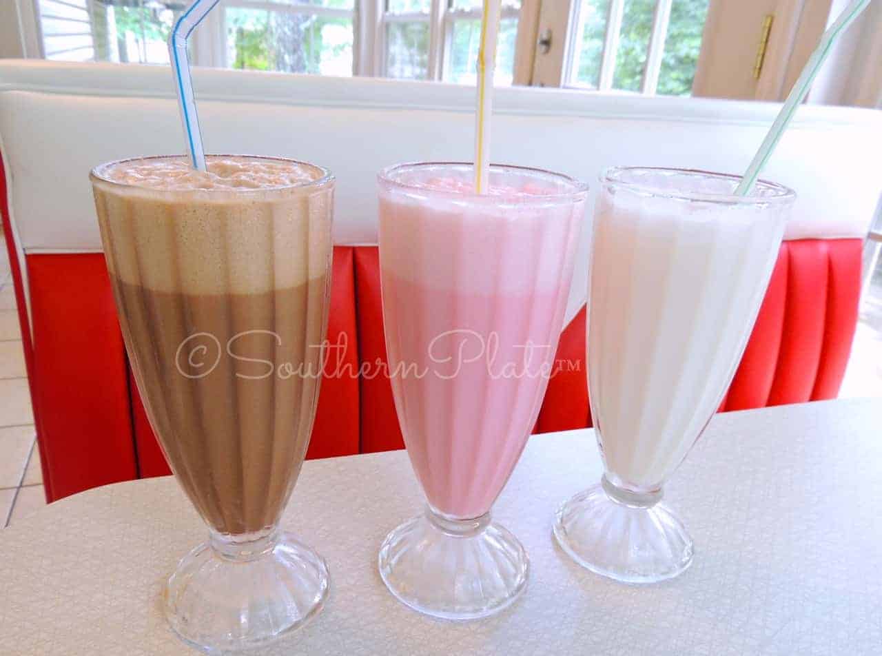 Chocolate, strawberry, and vanilla egg creams in a row.