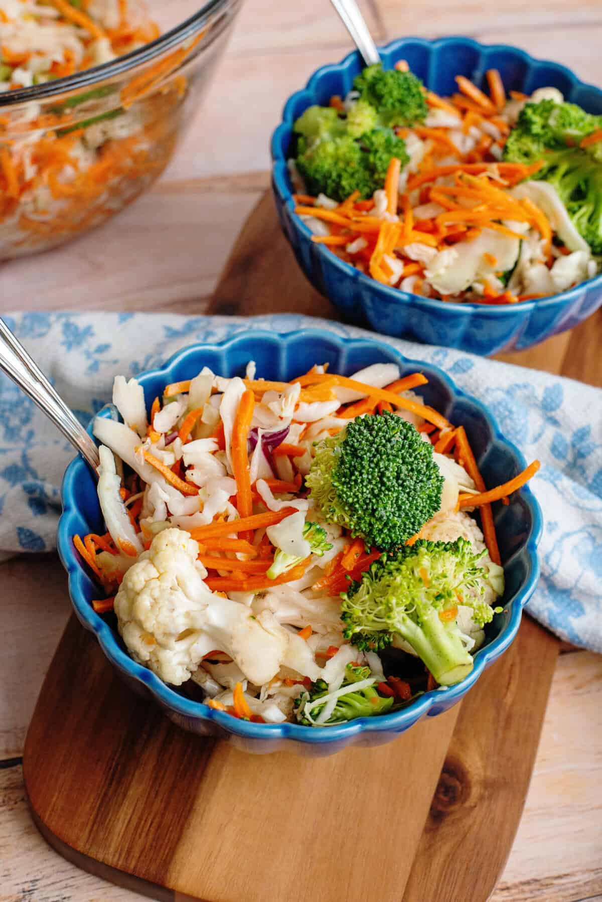 Two blue bowls of crunchy refrigerator salad.