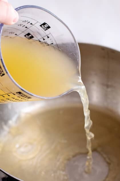 Add chicken broth to stockpot.