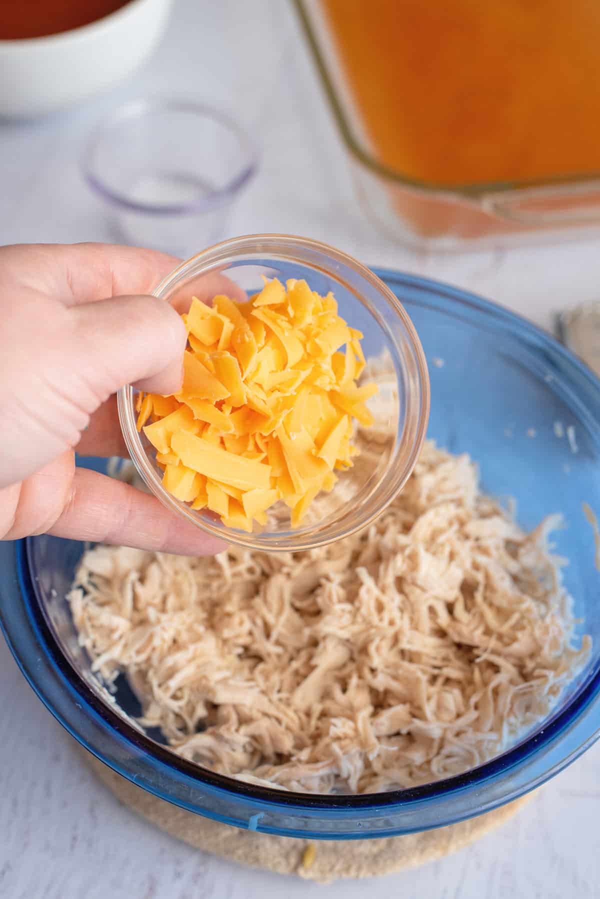 Add cheese to chicken in mixing bowl.