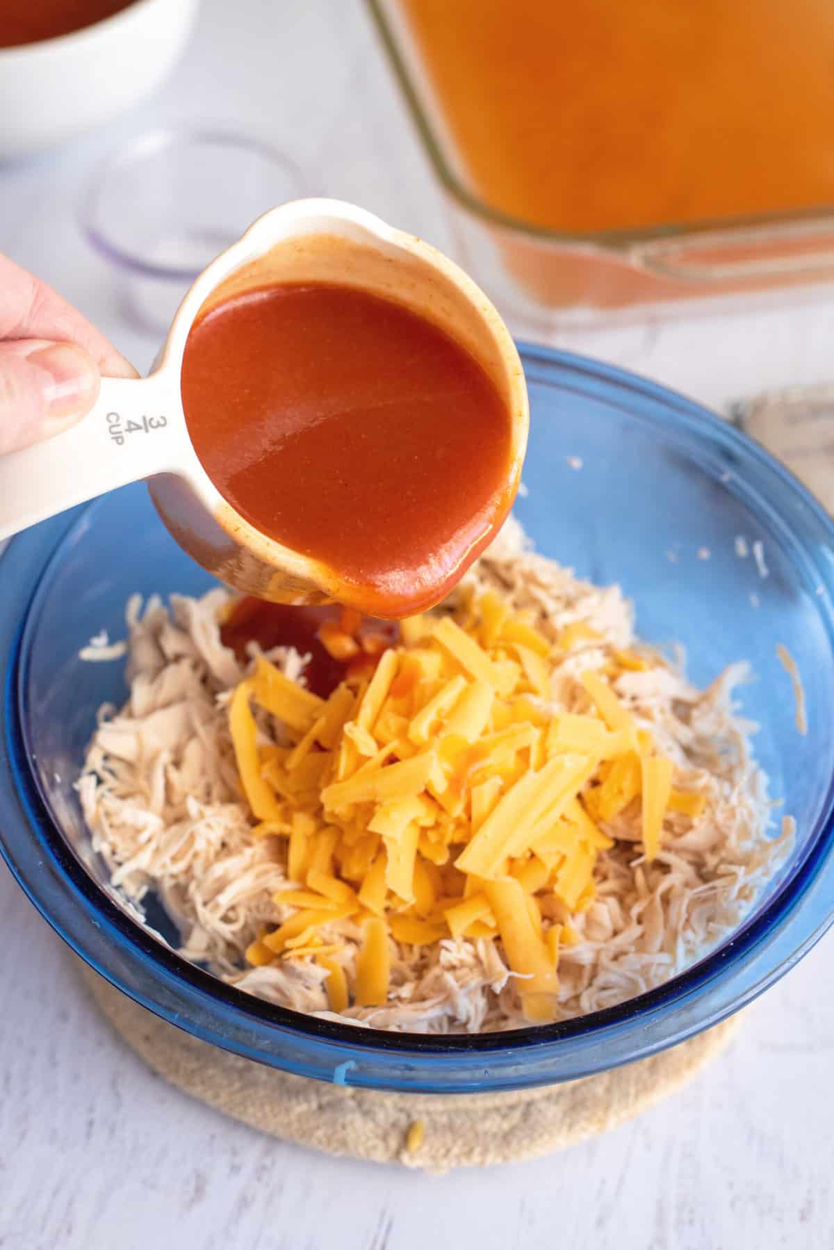 Add enchilada sauce to mixing bowl.