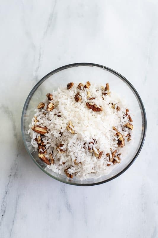 Quickly mix together coconut and pecans.