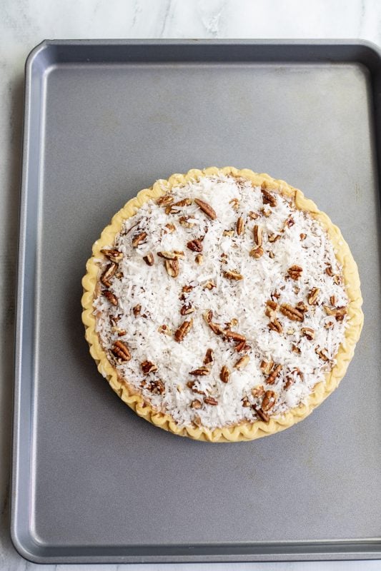 Add coconut/pecan mixture to the top of the pie and bake.