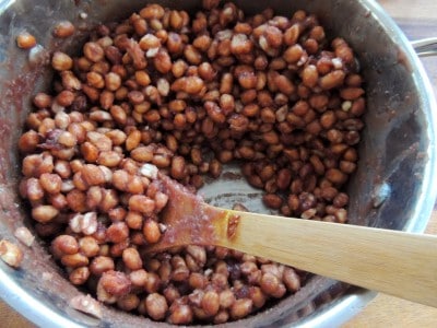 Sugar-coated peanuts in saucepot.