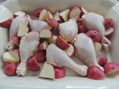 Arrange chicken and potatoes in baking dish.