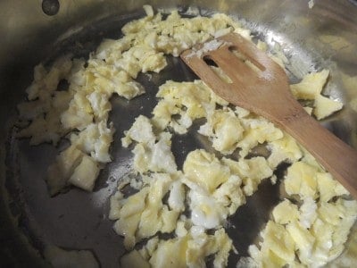 Scramble eggs in skillet.