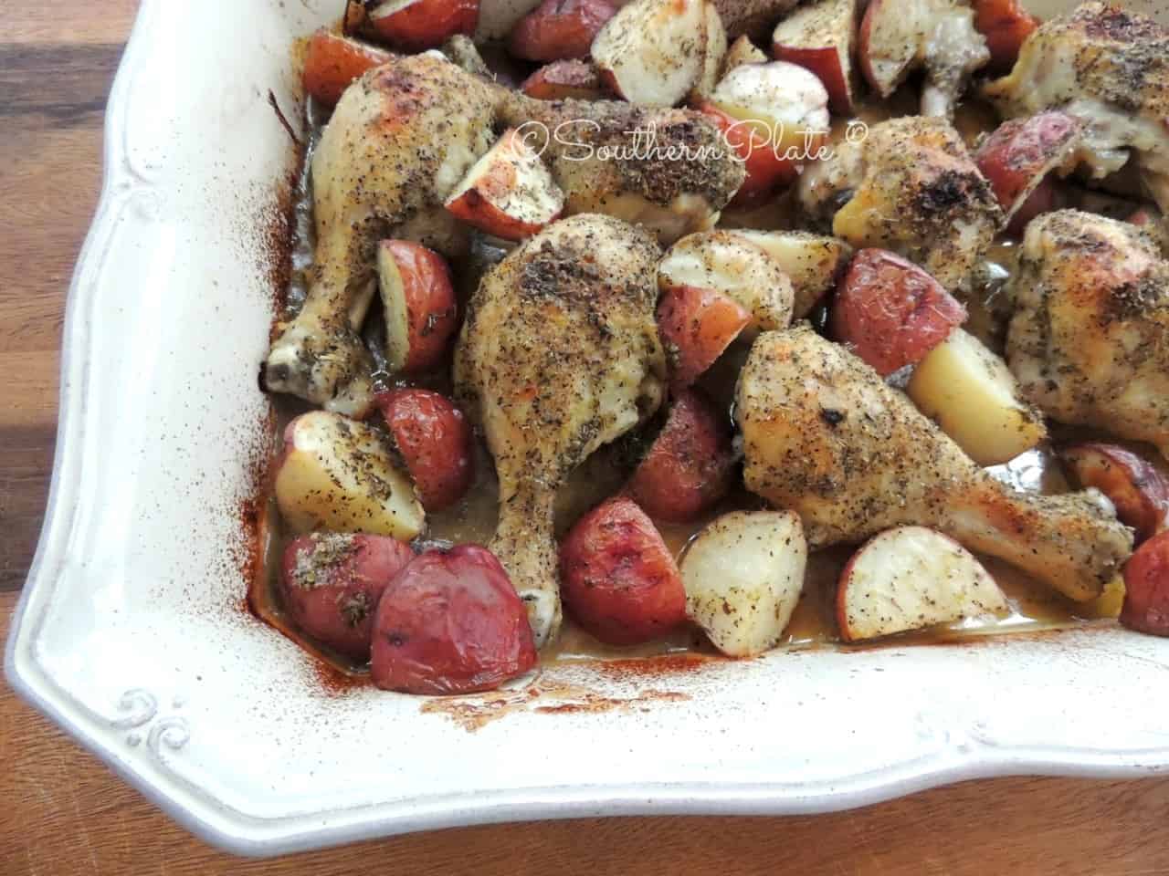 Greek Chicken and Potatoes in baking dish.