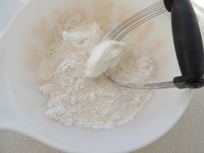 Cut shortening into flour in mixing bowl.