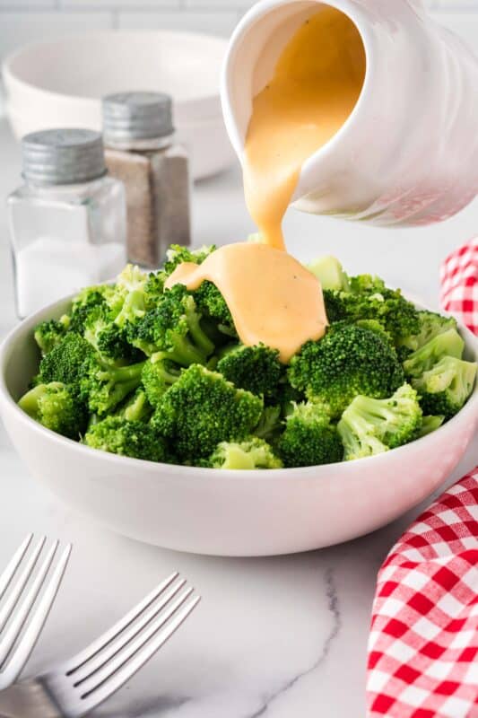 Pour cheese sauce over the broccoli.
