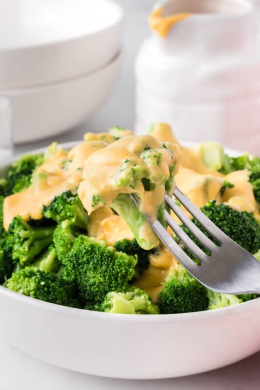 Fork of broccoli with cheese sauce