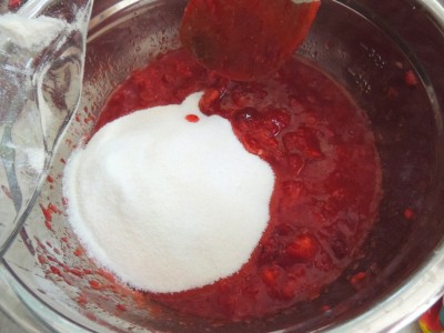 Add sugar to mashed strawberries and stir until dissolved.