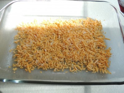 Add a layer of cheese to the bottom of the casserole dish.
