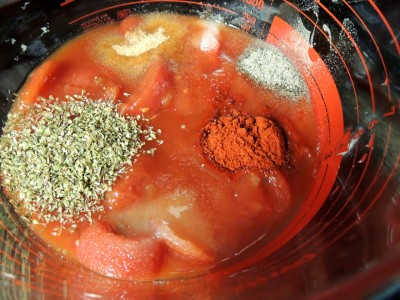 Place tomatoes, tomato sauce, and seasonings in a bowl.