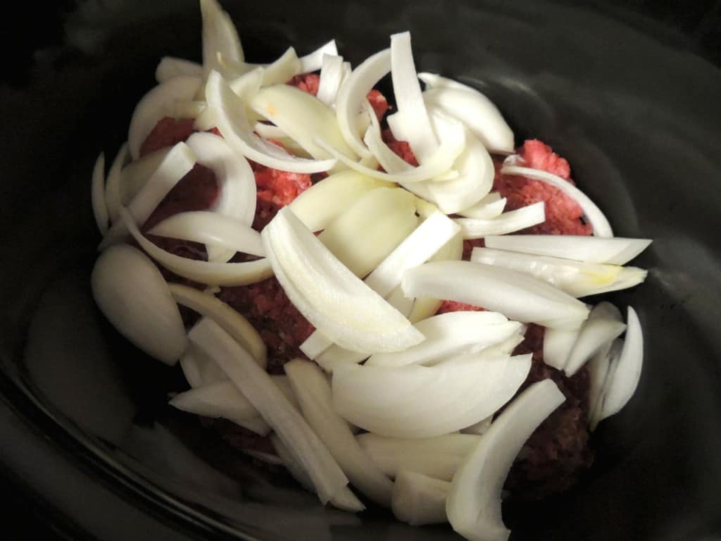 Top steak in slow cooker with onions.