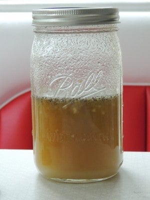 Mason jar showing the marinade mixed and ready to be poured over our 3 Bean Salad.